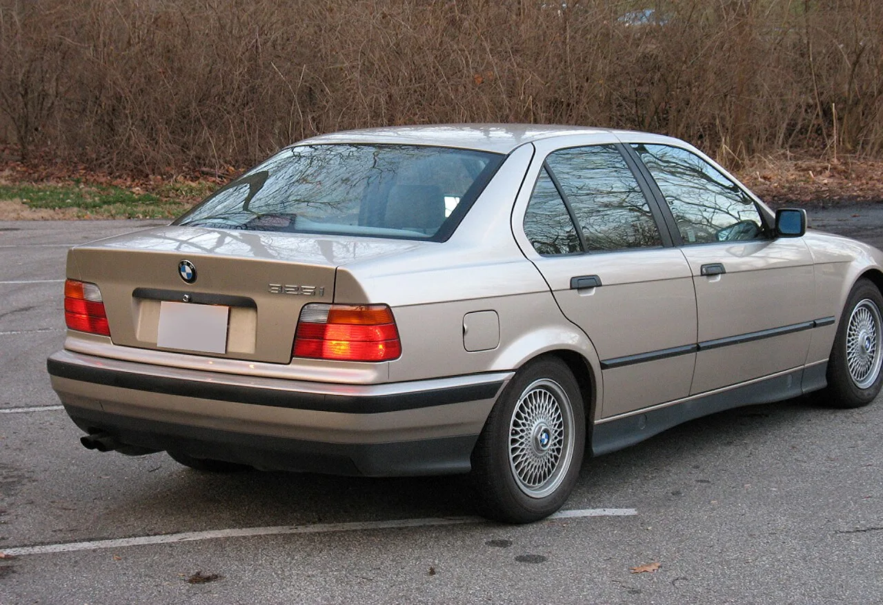 BMW E36 325i 후면부, 골드 색상 차체와 325i 배지가 보인다