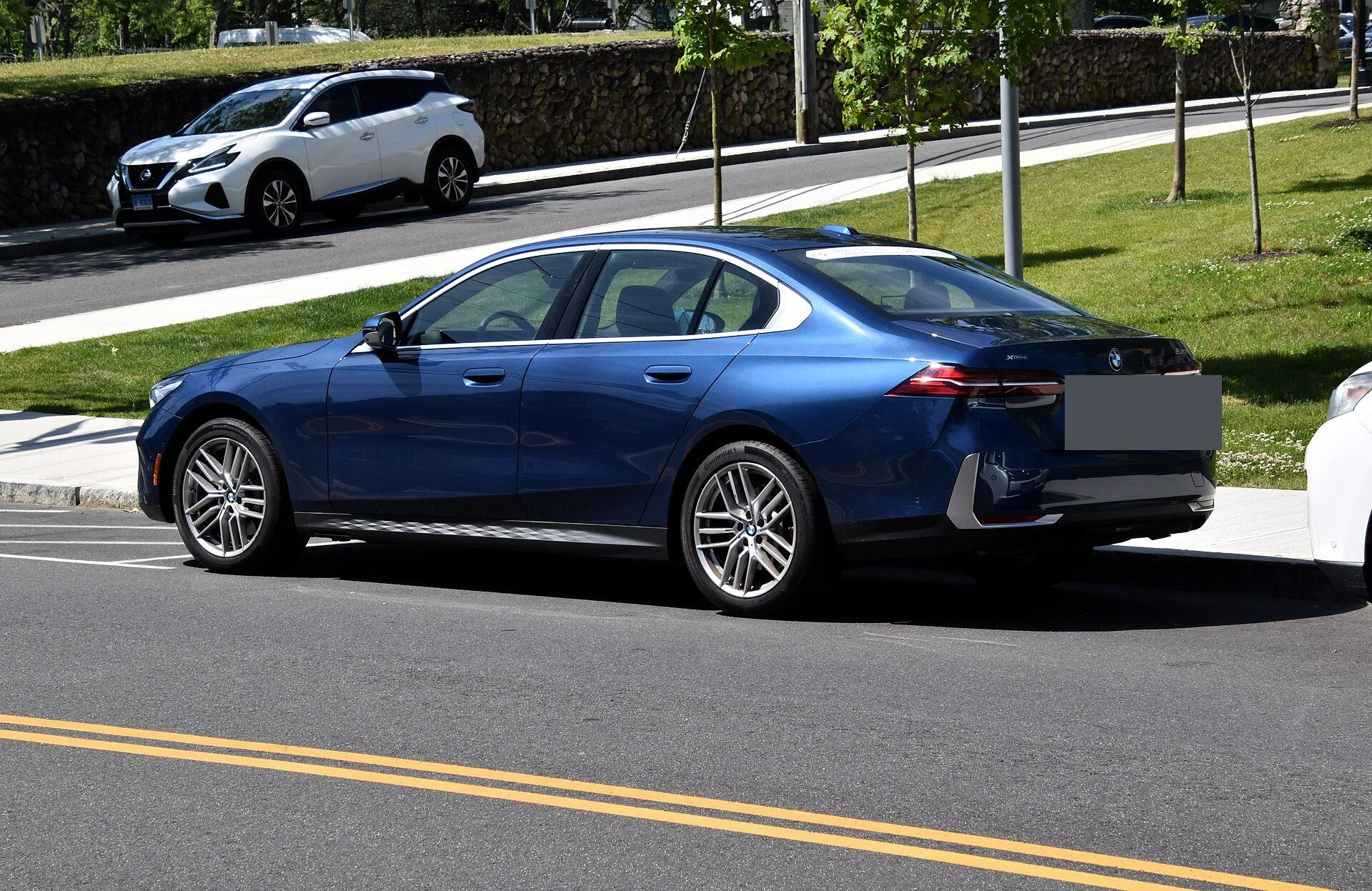 파란색 BMW 5시리즈 G60 세단 후측면 사진, 번호판 부분은 회색으로 가려져 있다