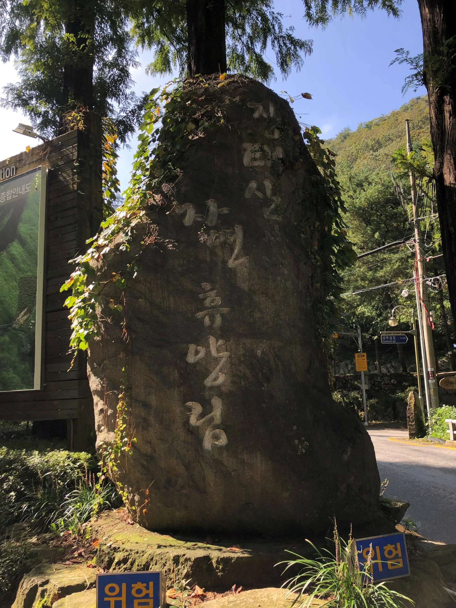 장태산자연휴양림 입구에 세워진 표지석과 뒤로 보이는 숲길