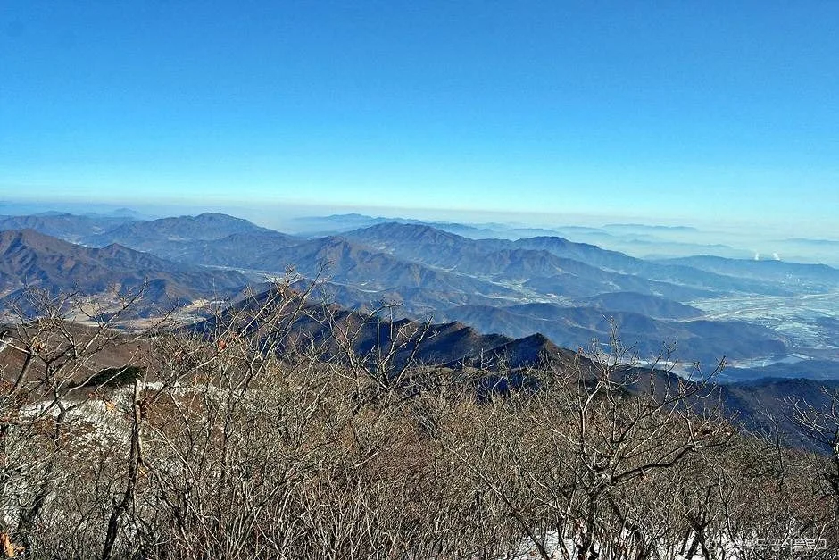 정상 부근에서 내려다본 겹겹의 능선과 푸른 하늘
