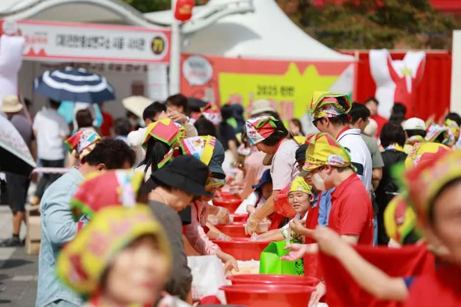 빨간 모자를 쓴 참가자들이 물통을 놓고 게임 체험을 즐기는 모습