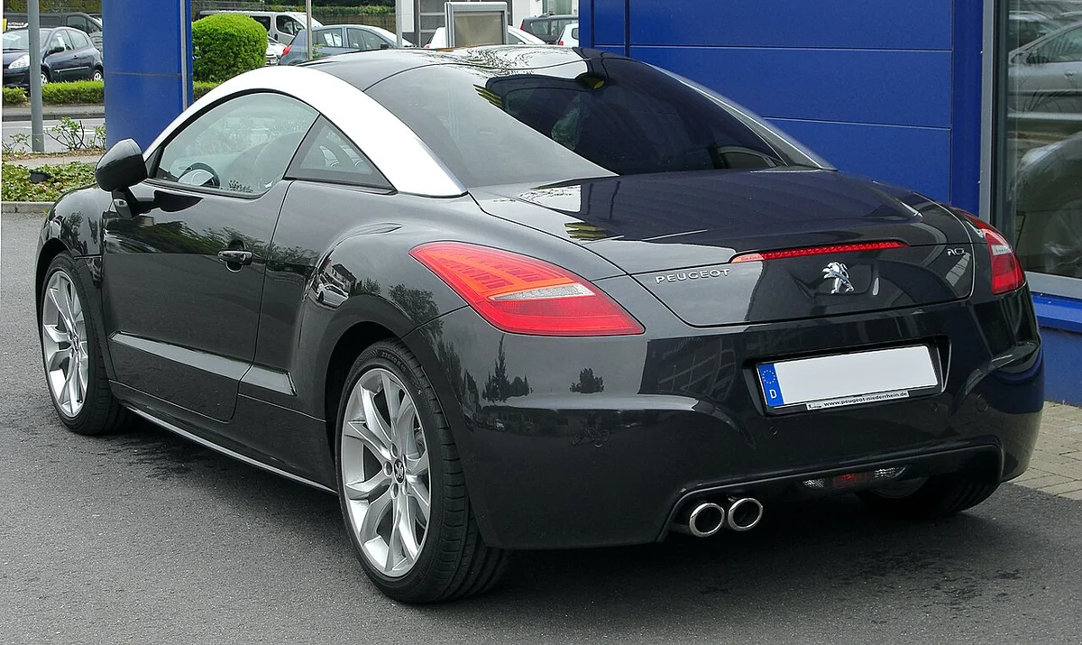 검은색 푸조 RCZ 쿠페의 후면, 듀얼 배기구와 곡선형 루프가 보인다